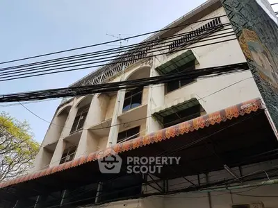 Vintage building exterior with unique architectural details and awning