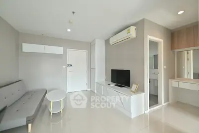 Modern living room with sleek design, featuring a cozy sofa, wall-mounted TV, and air conditioning unit.