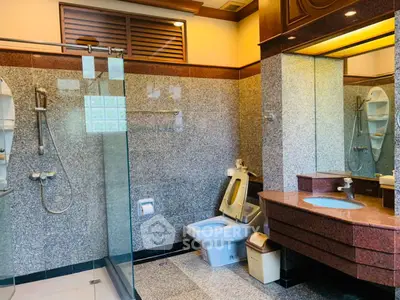 Luxurious bathroom with modern fixtures and elegant granite finishes.