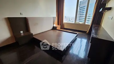 Spacious bedroom with city view and modern wooden flooring