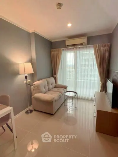 Cozy living room with modern decor, featuring a plush sofa, sleek TV unit, and large window for natural light.