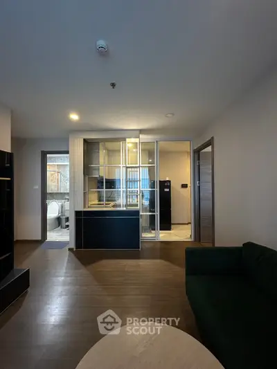 Modern open-plan living room with sleek kitchen and wooden flooring