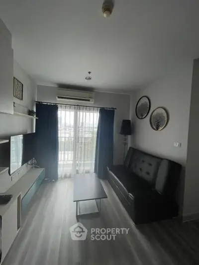 Modern living room with sleek furniture and large window view