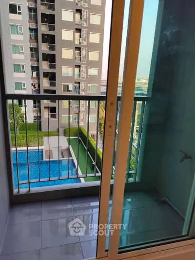 Modern apartment balcony with pool view and cityscape