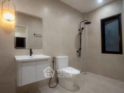 Modern bathroom with sleek fixtures and elegant lighting in a contemporary home.