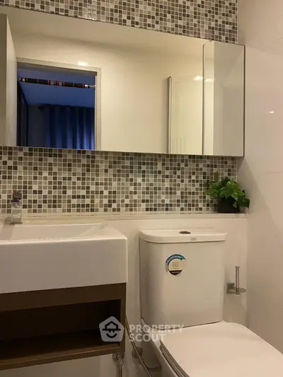 Modern bathroom with stylish mosaic tiles and sleek fixtures