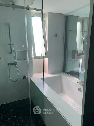 Luxurious bathroom with modern bathtub and sleek glass shower enclosure
