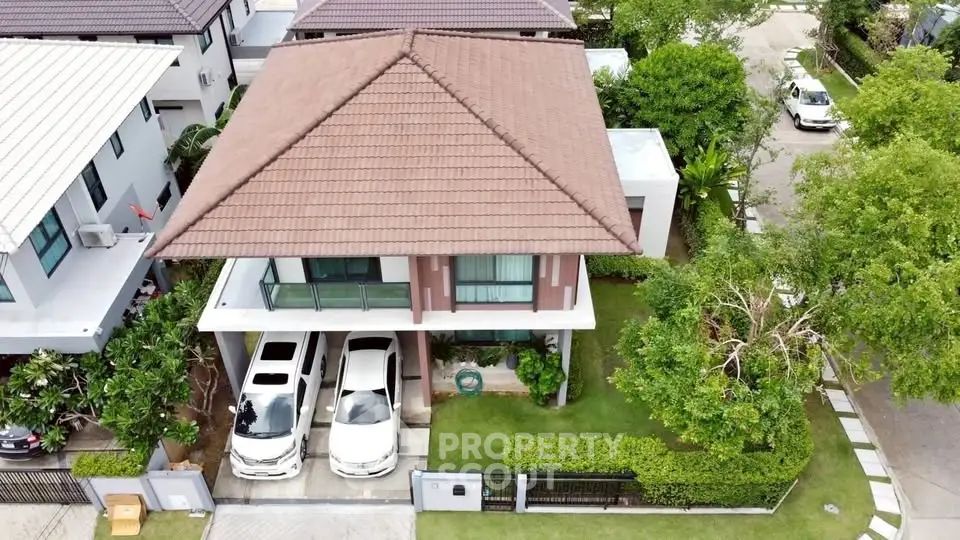 Charming two-story house with spacious driveway and lush garden in a serene neighborhood.