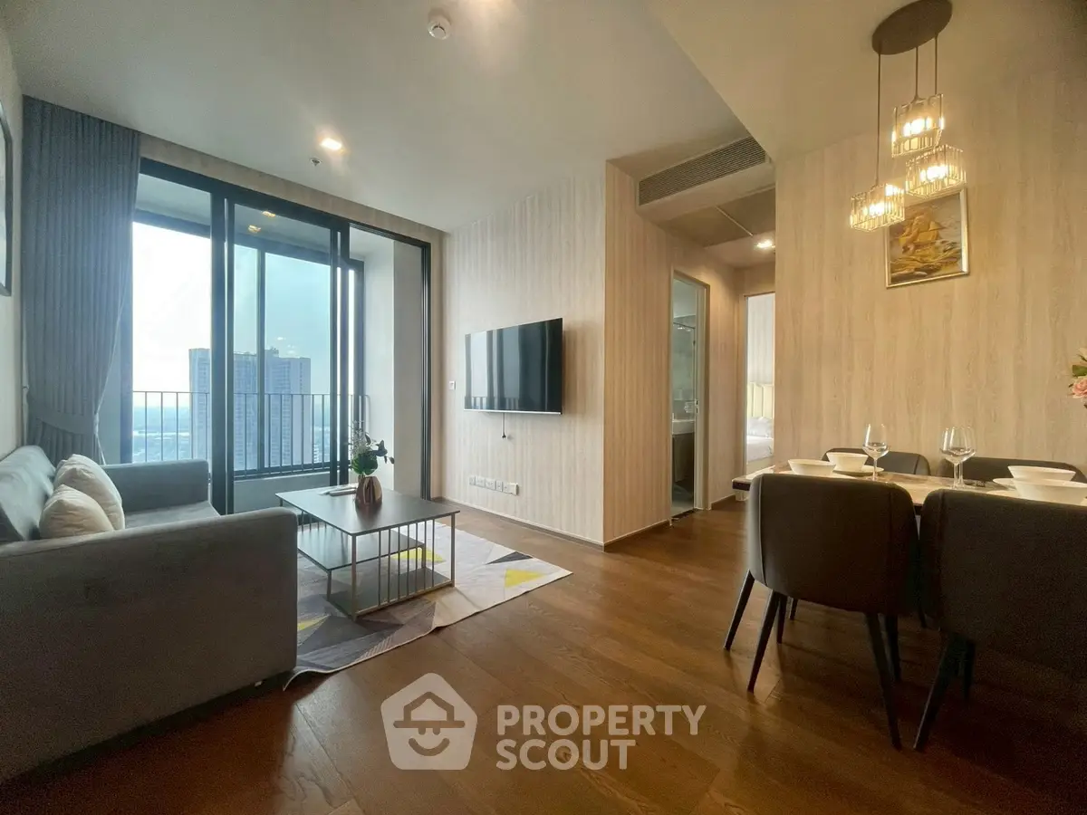 Modern living room with elegant dining area and city view balcony.