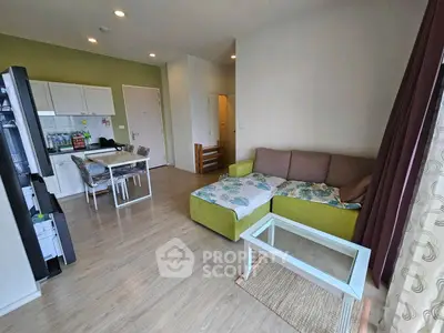 Spacious living room with modern decor and open kitchen layout in a stylish apartment.