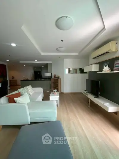 Spacious modern living room with stylish decor and natural light