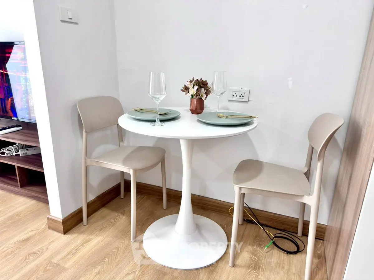 Cozy dining nook with modern table and chairs, perfect for intimate meals in a stylish apartment.