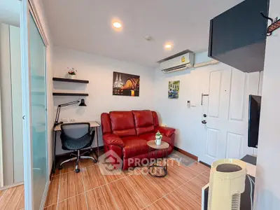 Cozy living room with red leather sofa and modern decor in a stylish apartment.
