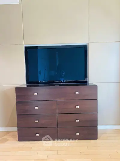 Modern dresser with flat-screen TV in stylish living room setting.