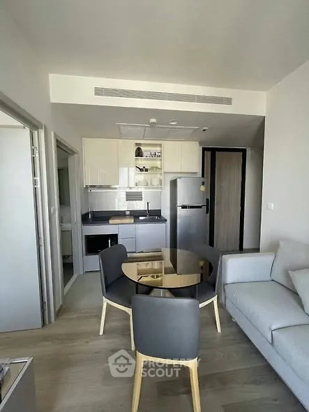 Modern open-plan living room with sleek kitchen and stylish furniture