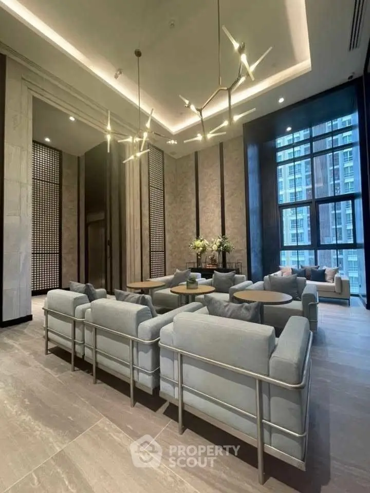 Luxurious modern living room with elegant lighting and large windows in high-rise building.