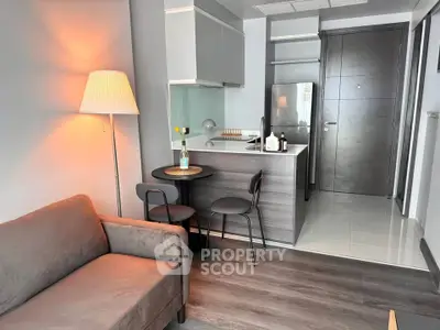 Modern studio apartment with cozy living area and compact kitchen, perfect for urban living.