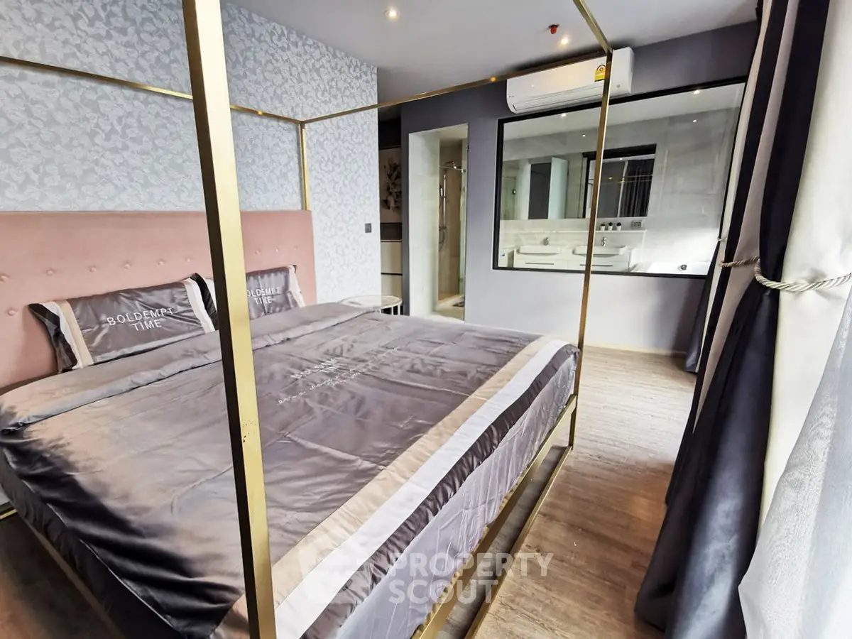 Luxurious bedroom with elegant decor and large mirror, featuring a stylish bed and modern air conditioning.