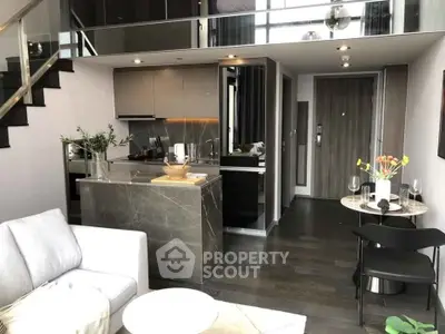 Modern open-plan living room with stylish kitchen in a chic apartment