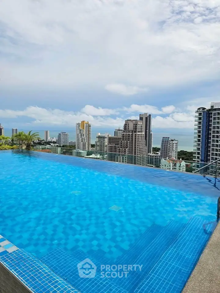 Stunning rooftop infinity pool with panoramic city and ocean views.