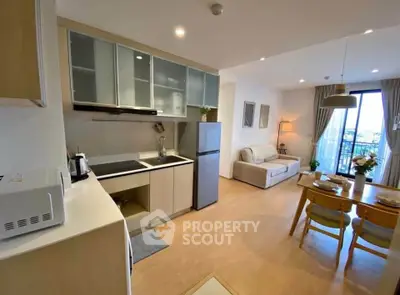 Modern open-plan kitchen and living room with city view and stylish decor.