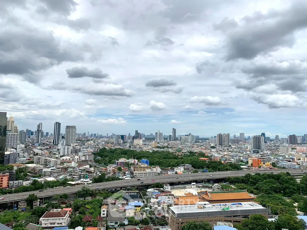 Stunning cityscape view showcasing urban skyline and lush greenery, perfect for real estate investment.