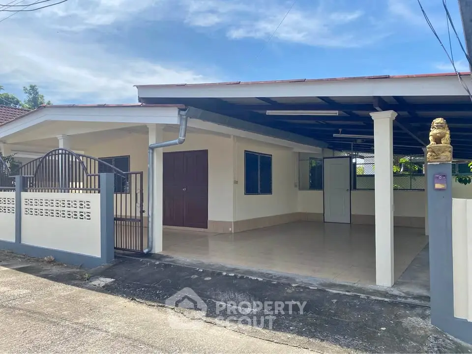 Charming single-story home with spacious carport and gated entrance in a serene neighborhood.