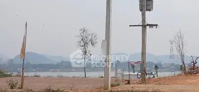 Scenic land plot with mountain and river view, ideal for development.