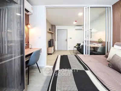 Modern bedroom with study area and stylish decor in a contemporary apartment.