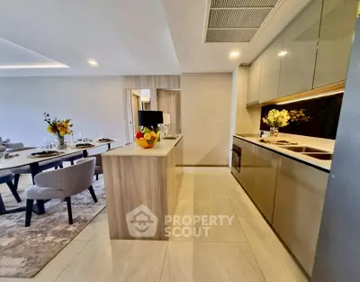 Modern open layout kitchen and dining area with sleek design and elegant decor.