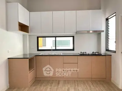 Modern kitchen with sleek cabinetry and gas stove in a bright, minimalist design.