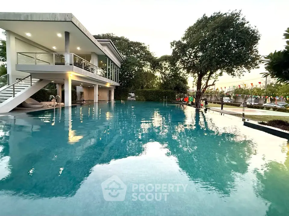 Luxurious residential pool with modern architecture and lush greenery, perfect for relaxation and leisure.