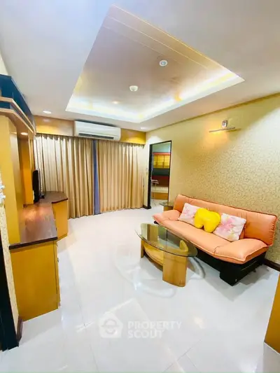 Spacious living room with modern decor and cozy seating area, perfect for relaxation and entertainment.