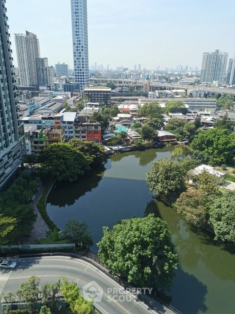 Stunning urban view with high-rise buildings and serene lake, perfect for city living enthusiasts.