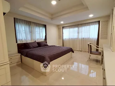 Spacious bedroom with elegant decor and natural light