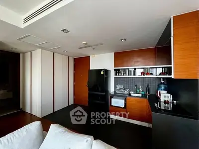 Modern kitchen with sleek cabinetry and appliances in a stylish apartment.