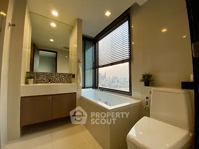 Luxurious bathroom with city view, featuring modern fixtures and a spacious bathtub.