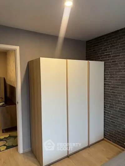 Modern bedroom with sleek wardrobe and stylish brick accent wall