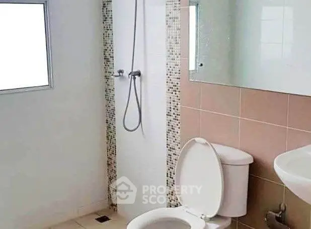 Modern bathroom with sleek shower and neutral tiles, perfect for a minimalist home.