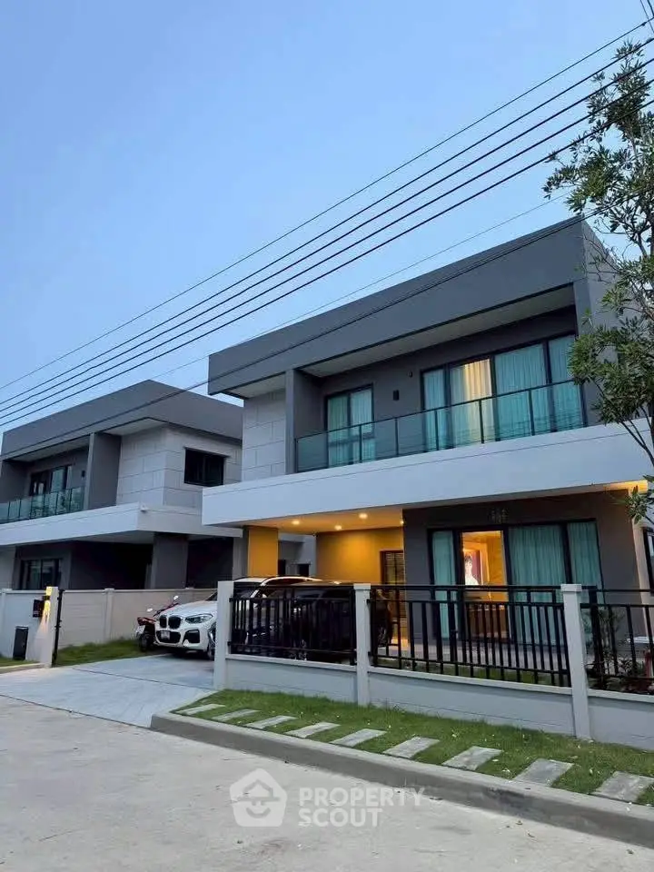 Modern two-story house with sleek design and spacious driveway in a serene neighborhood.