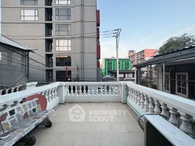 Spacious balcony with urban view in modern apartment complex