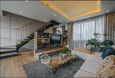 Luxurious modern living room with stylish staircase and cozy seating area.