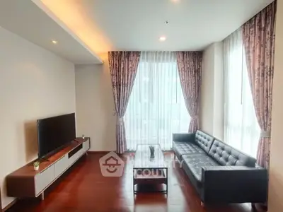 Spacious living room with modern decor and large windows for natural light.