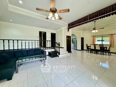Spacious living and dining area with elegant ceiling fans and tiled flooring
