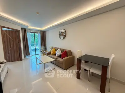 Modern living room with stylish decor and large windows offering a serene garden view.