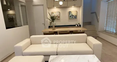 Modern living room with elegant dining area and stylish decor