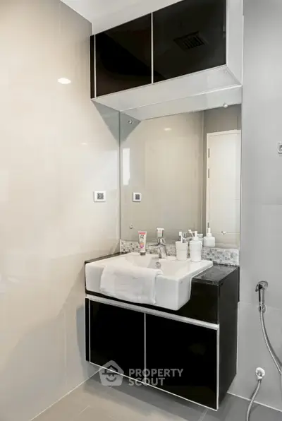 Modern bathroom with sleek black cabinetry and stylish fixtures