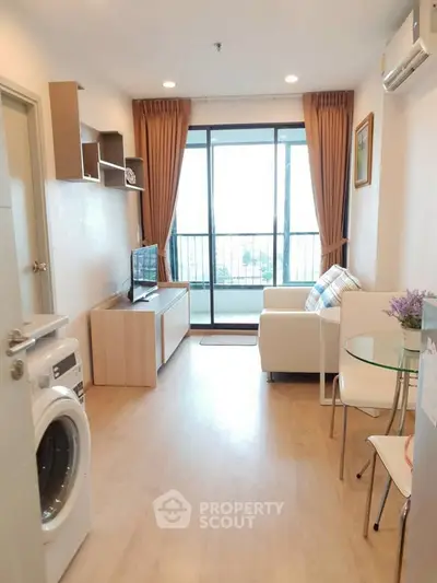 Modern living room with balcony view, washing machine, and cozy seating area.
