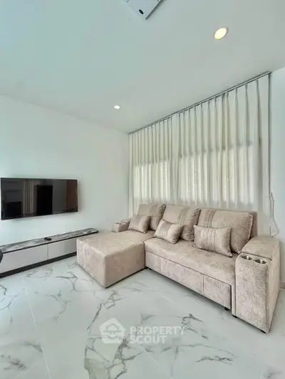 Modern living room with elegant marble flooring and cozy beige sofa
