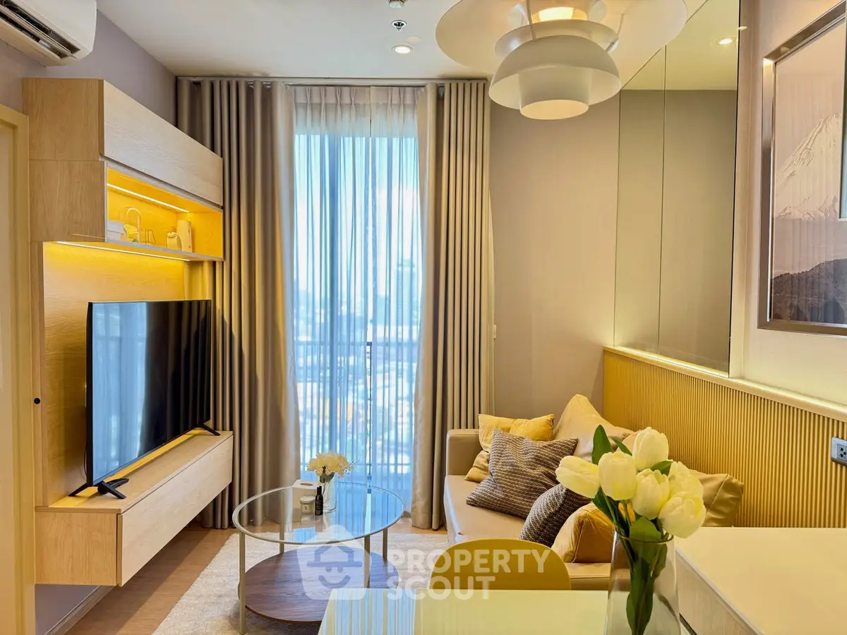 Modern living room with stylish decor and large window offering city views
